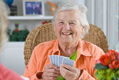 image of elderly woman playing a card game